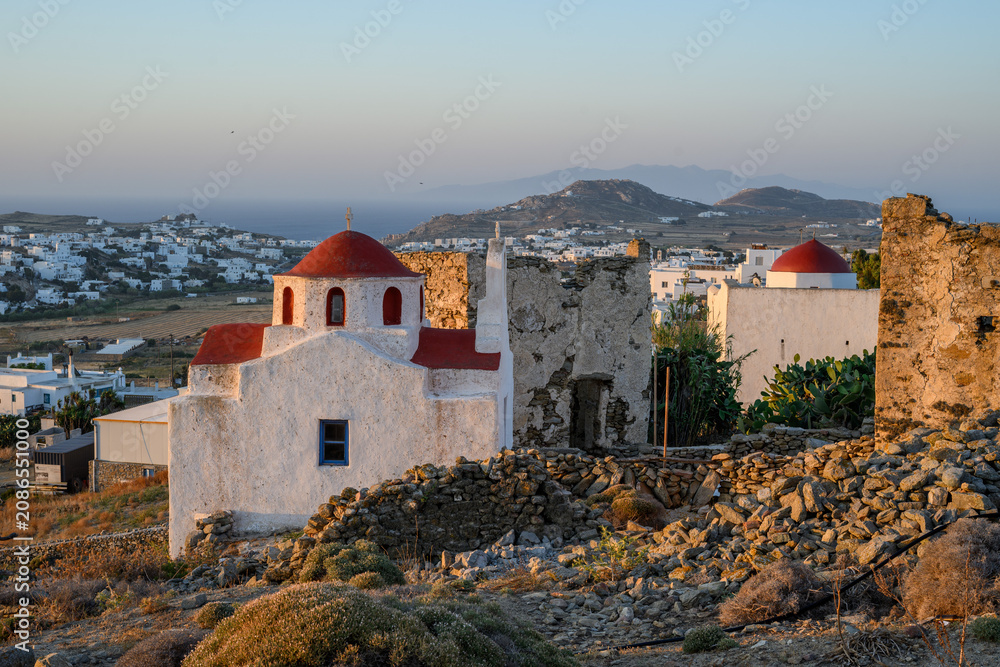 Obraz premium White Church with Red Domes above Ano Mera Village at Golden Hour, Mykonos, Greece