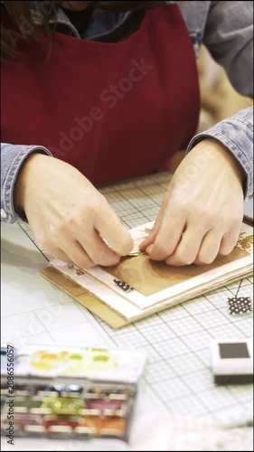 Woman's hands creating handmade scrapbooking card