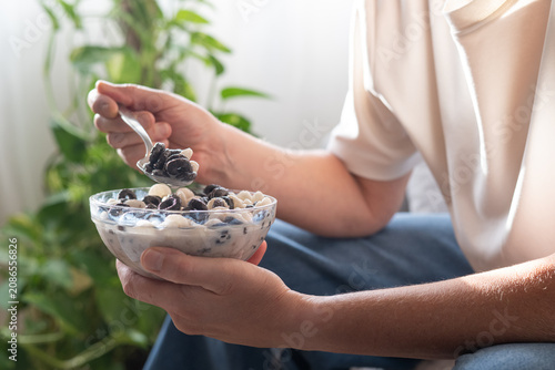 Cuadro en lienzo Person savoring a bowl of milky breakfast cereal, embracing a slow morning routi