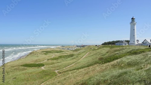 Hirtshals lighthouse standing on a green grassy danish coastline