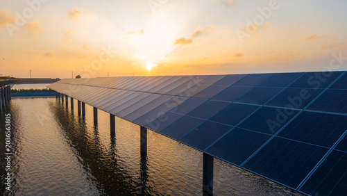 Floating Solar Panels Installed on Water at Sunset
