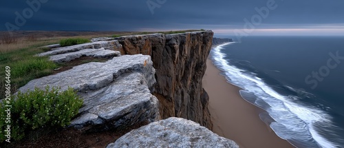 Lone cliff edge overlooks stormy ocean with dark skies and massive waves crashing below in a dramatic landscape scene