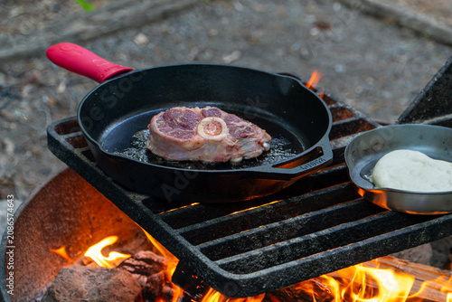 Cooking Steak over Campfire in Cast Iron Skillet