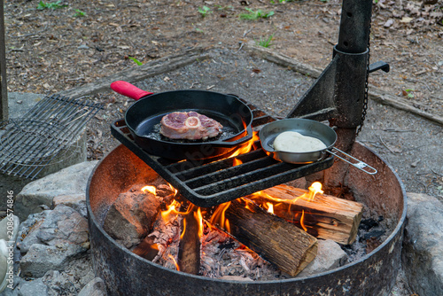 Cooking Steak over Campfire in Cast Iron Skillet