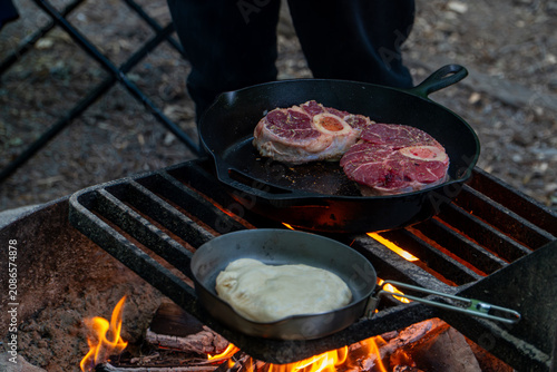 Cooking Steak over Campfire in Cast Iron Skillet