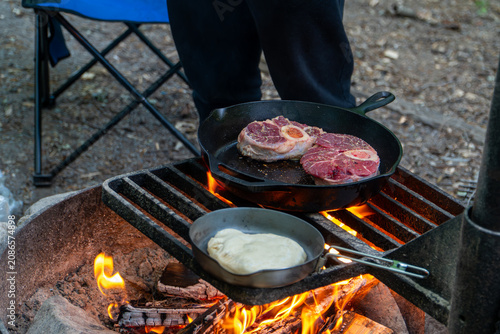 Cooking Steak over Campfire in Cast Iron Skillet