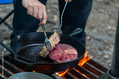 Cooking Steak over Campfire in Cast Iron Skillet