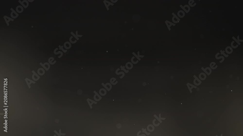 Floating dust particles over dark background with shallow focus