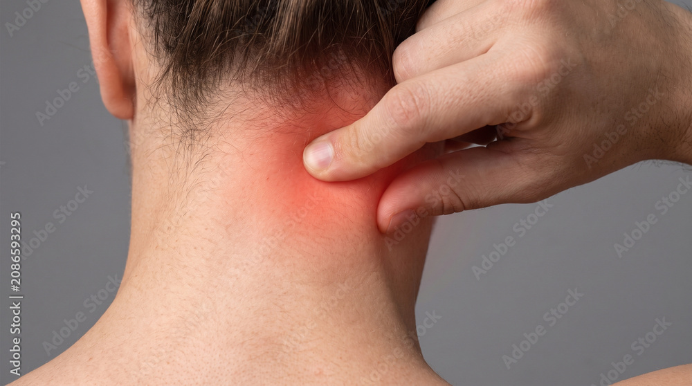 Naklejka premium Person touching their painful neck area with a bright red glow indicating severe muscle tension