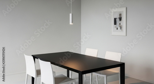 Modern dining room with black table and white chairs