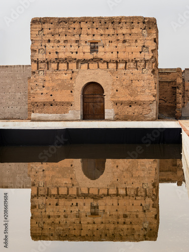 Ancient Royal Palace Ruins and Symmetrical Pool Reflection in Marrakech, Morocco
