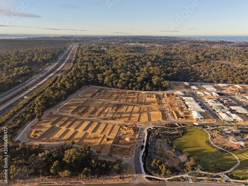 Quadro su tela Golden Hour Aerial View of New Residential Housing Development Beside Native Bus