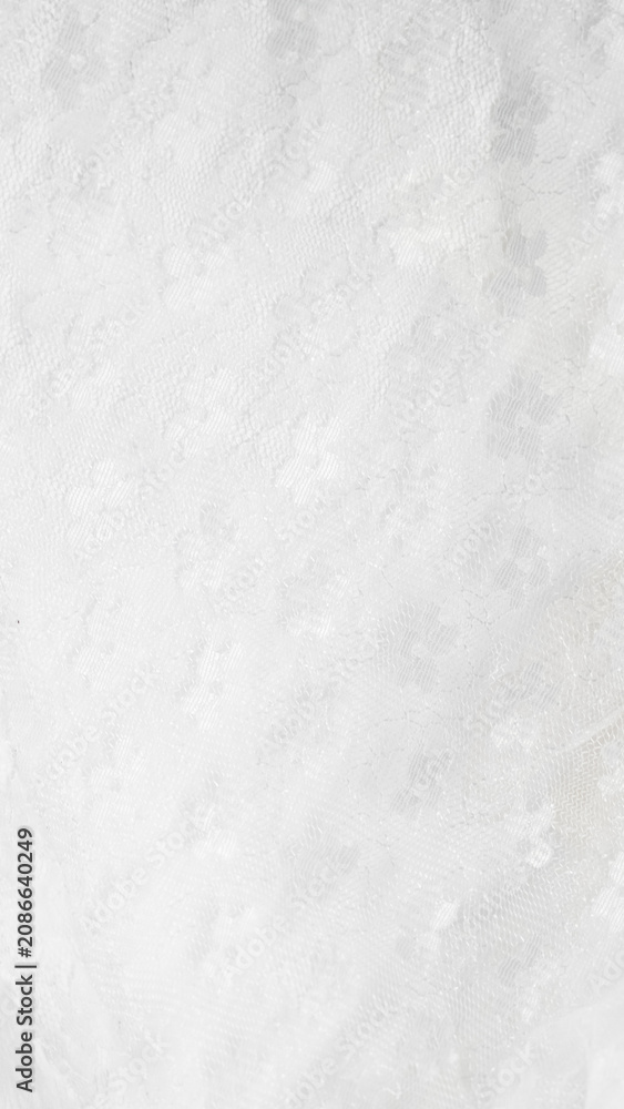 Fototapeta premium Delicate white floral lace fabric texture backdrop.