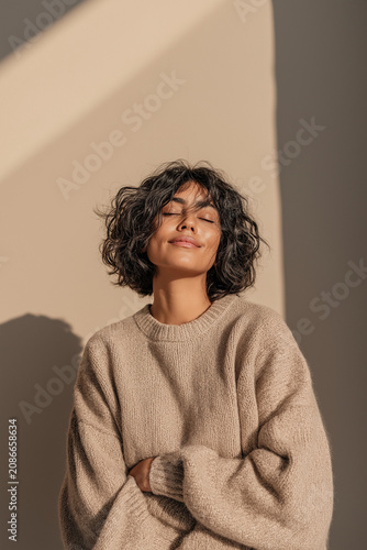 Woman Dark Curly Bob Eyes Closed Arms Crossed Sunlit Serene Calm Mindful