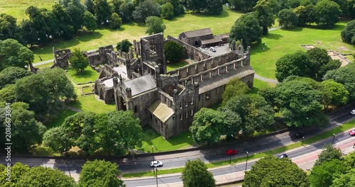 Aerial drone footage of the historic ruins of Kirkstall Abbey in Leeds West Yorkshire England on a bright summer day showcasing one of Britain’s best preserved medieval monasteries