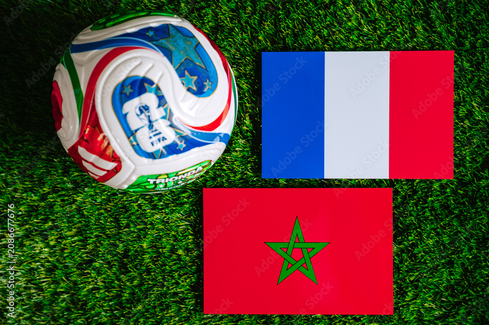 Fototapeta premium FIFA World Cup 2026 quarterfinal: France vs Morocco, national flags before international football match. Editorial football scene on green grass pitch inside stadium light, Foxborough, United States.
