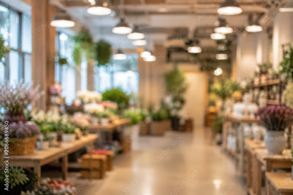 Obraz premium blurred flower shop interior florist retail store boutique plant nursery garden center floral shop abstract background bokeh lighting indoor