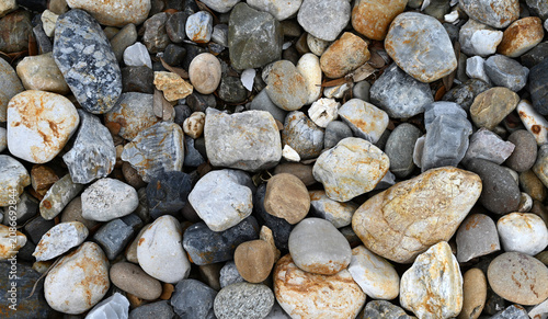 Fotografie Horizontal close up of smooth landscape rocks in various colors sizes and shapes
