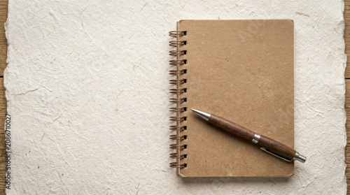 Brown spiral notebook and pen.