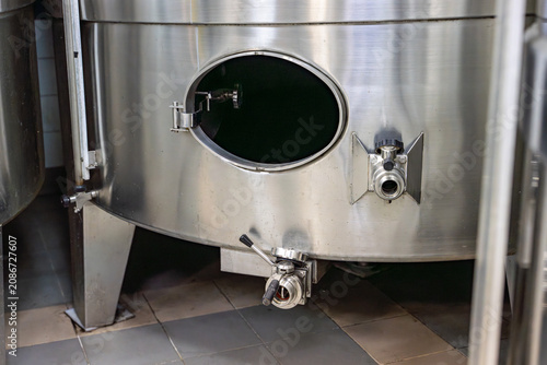 Bilde på lerret Stainless steel wine tank base with a valve