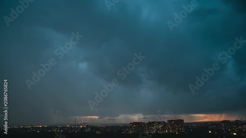 Storm clouds quickly pass over the city at sunset, timelapse
