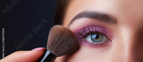 Close Up of Young Woman Applying Pink Eyeshadow with Makeup Brush Beauty Concept