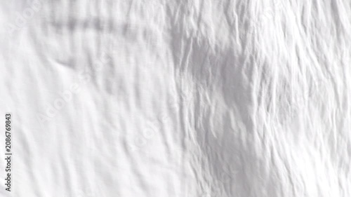 Soft white fabric background with crinkled texture waving