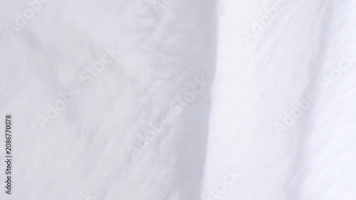 Soft white fabric background with crinkled texture waving