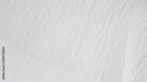 Soft white fabric background with crinkled texture waving