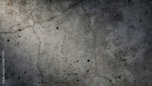 Close up macro shot of a weathered grey concrete wall texture showing small cracks and porous surface details