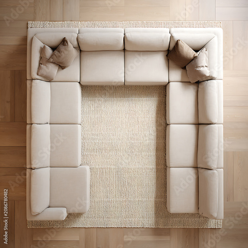 Modular sectional sofa arranged in square formation on textured area rug over light oak wood flooring for contemporary living room interior design and home staging project