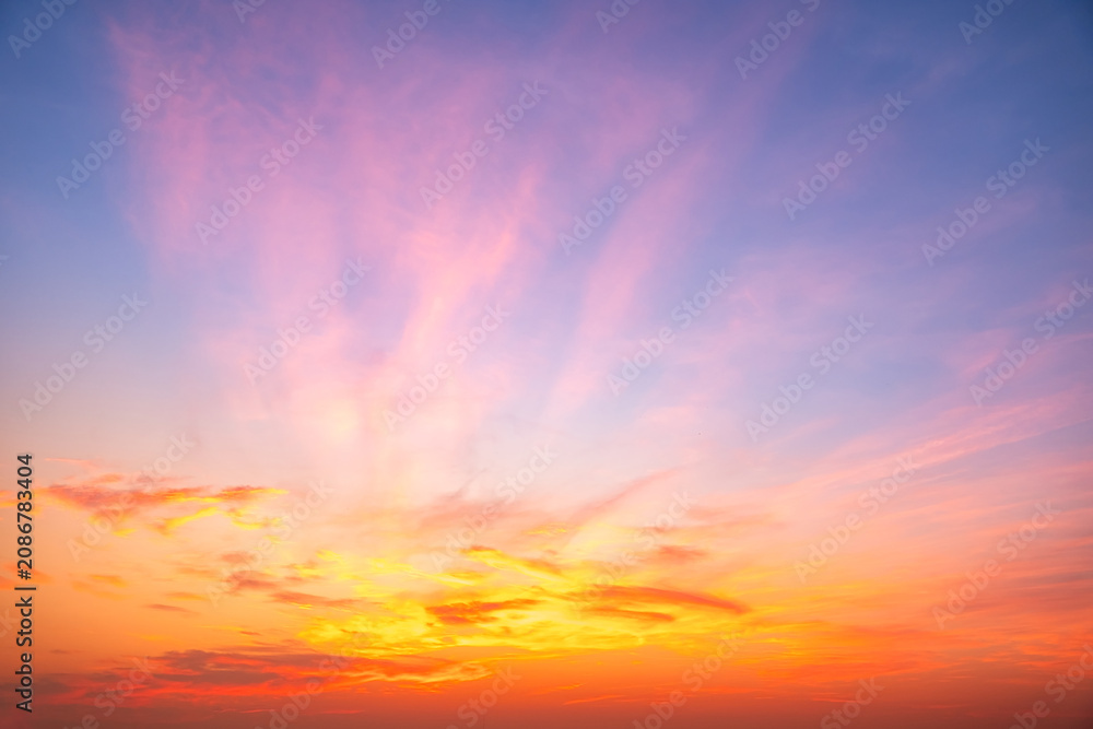 Fototapeta premium Sky sunset,Beautiful sunrise sky with vibrant gradient orange and gold colors and soft blue, Clear atmosphere with wispy clouds. Peaceful, perfect for background and copy space, High resolution images