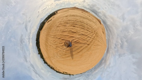 360-degree shot of alone man walking in the desert – a tourist exploring the desert on a hot, sunny afternoon during a trip