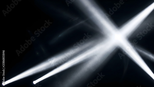 Bright white spotlights crossing in the dark, abstract stage light rays effect on black background