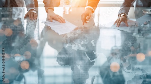 Global Business Negotiation Concept with World Map Overlay and Documents
