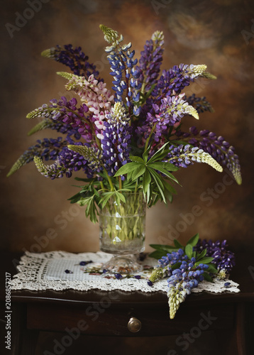 Still-life. A photo of a bouquet of lupins in a vase.