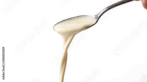 Creamy sauce, pouring from spoon, white background, culinary, food, kitchen