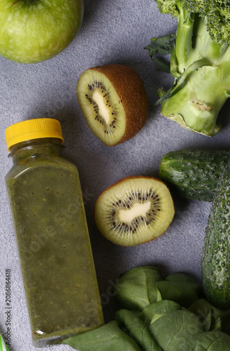 Healthy food smoothie in a bottle made from green vegetables and fruits