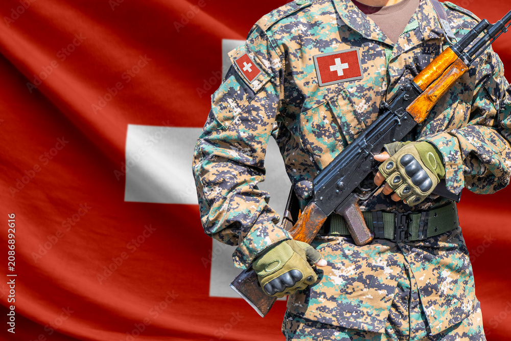Fototapeta premium Switzerland flag with soldier holding assault rifle
