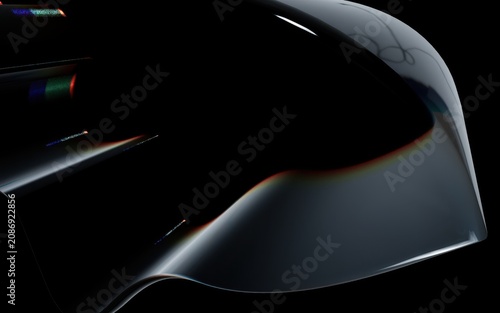 Photos A sleek black object with a shiny surface and rainbow reflections on a dark back