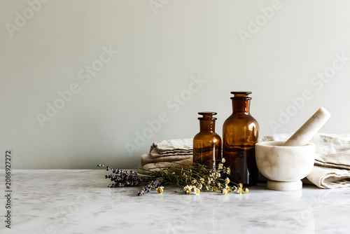 Apothecary wellness flat lay with amber bottles and herbs, copy space