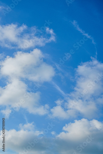 Bright Blue Sky With Soft White Clouds, Airy Cumulus Formations and Serene Daylight Atmosphere