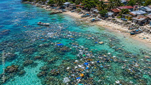 Reef lagoon near coastal village polluted by drifting plastic waste