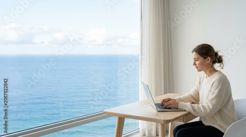 Remote work setup with ocean view through a window
