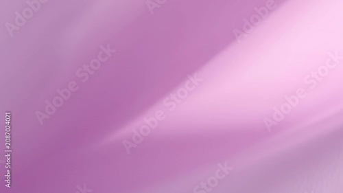 Slow pan across silk fabric flowing and shifting folds in studio close up backdrop with soft pink pastel tones