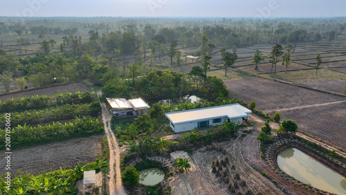 Obraz na plátně Farmhouse surrounded by cultivated farmland, irrigation ponds, banana plantations, and productive crop fields