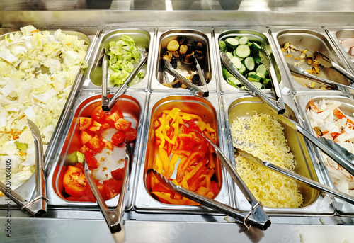Self-Serve Salad Bar Buffet With Fresh Toppings and Cold Salad Station in Restaurant.