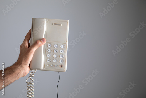 Tablou pe pânză Caucasian man showing telephone landline.