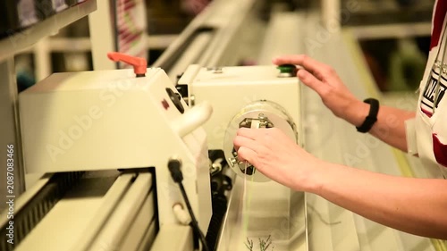 The process of machine operation at a factory manufacturing electrical wiring for cars.