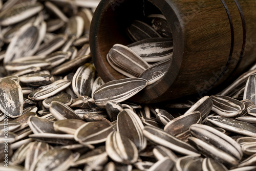 Sunflower seeds in a wooden bowl.